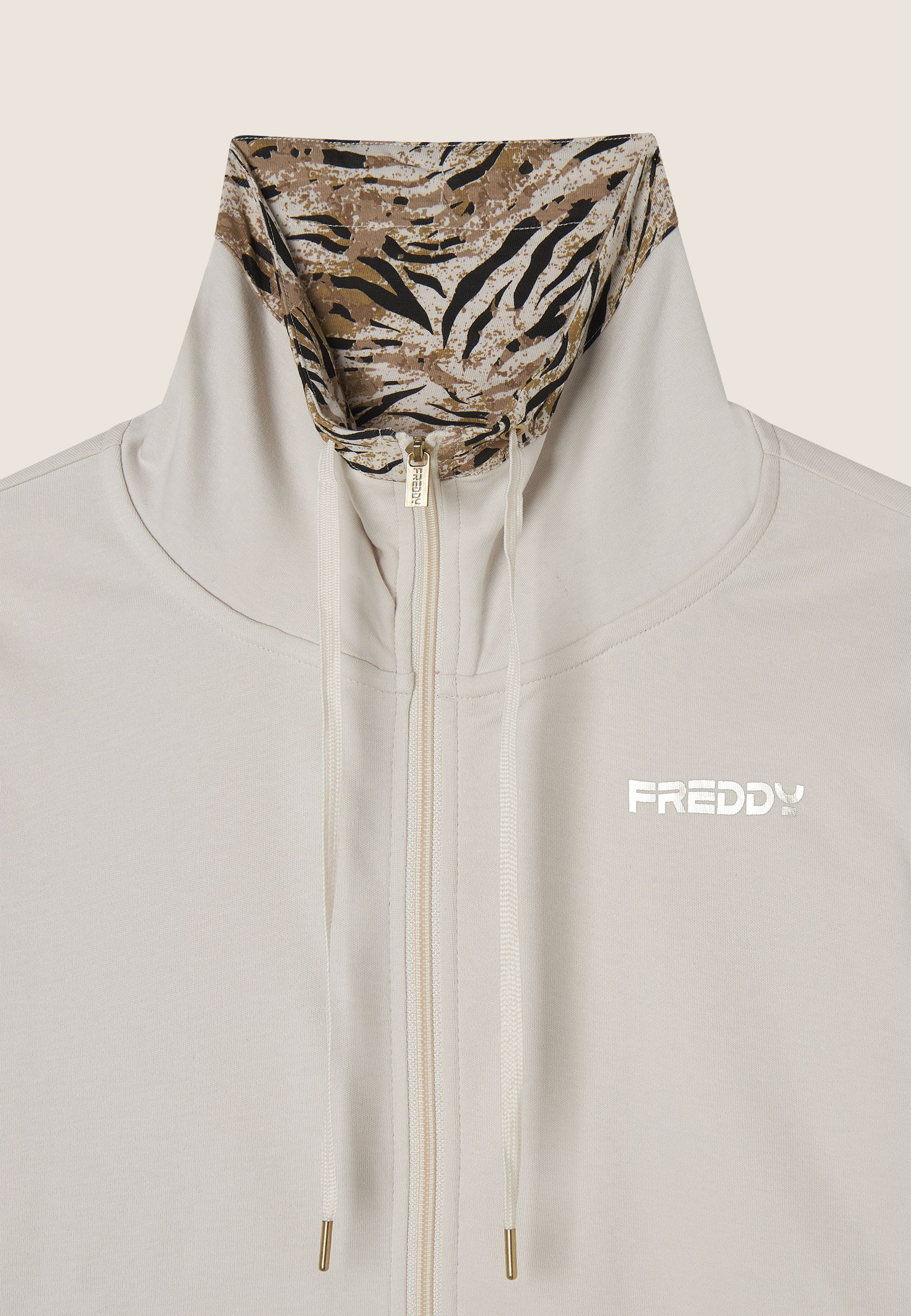 Tuta interlock con zip e collo alto interno fantasia