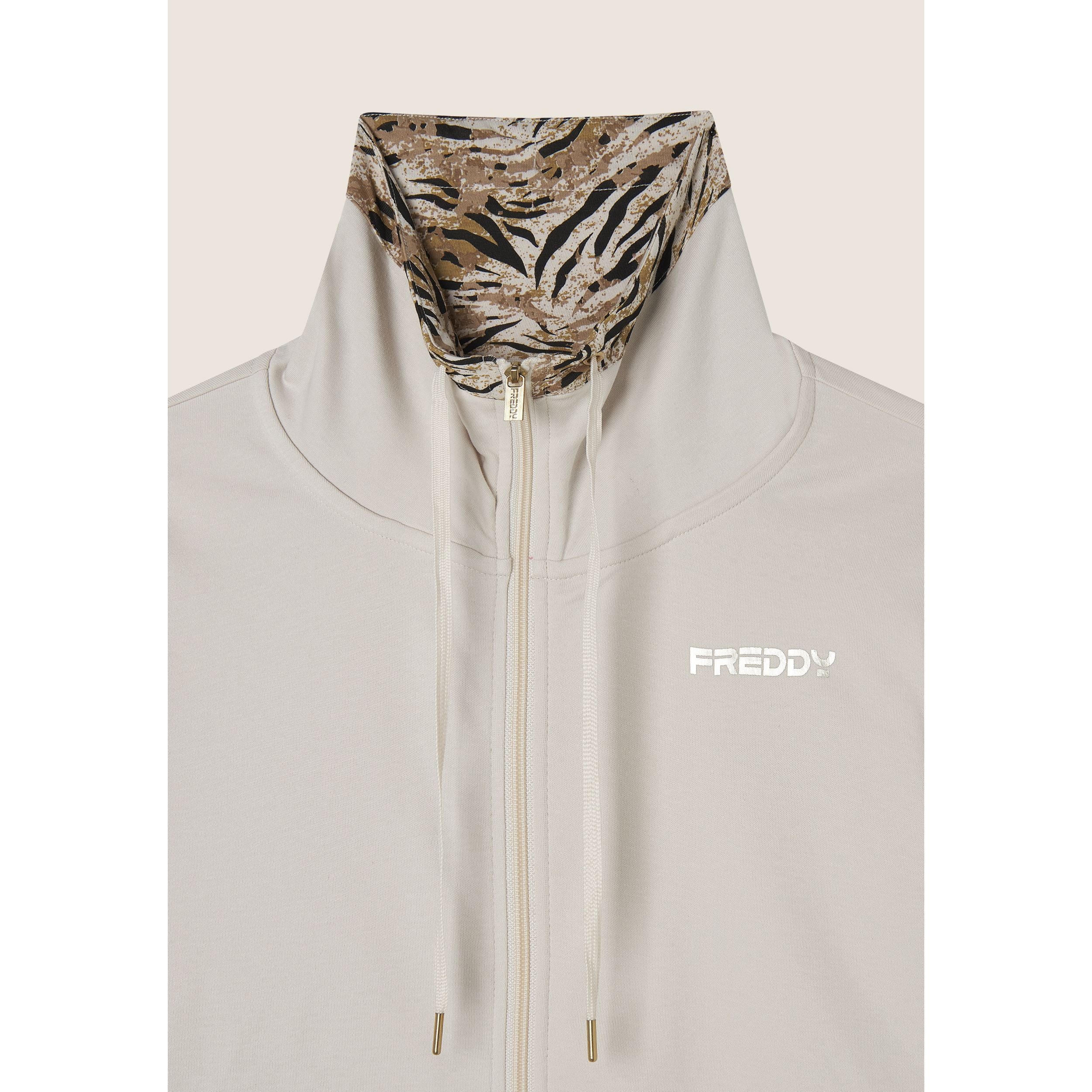 Tuta interlock con zip e collo alto interno fantasia